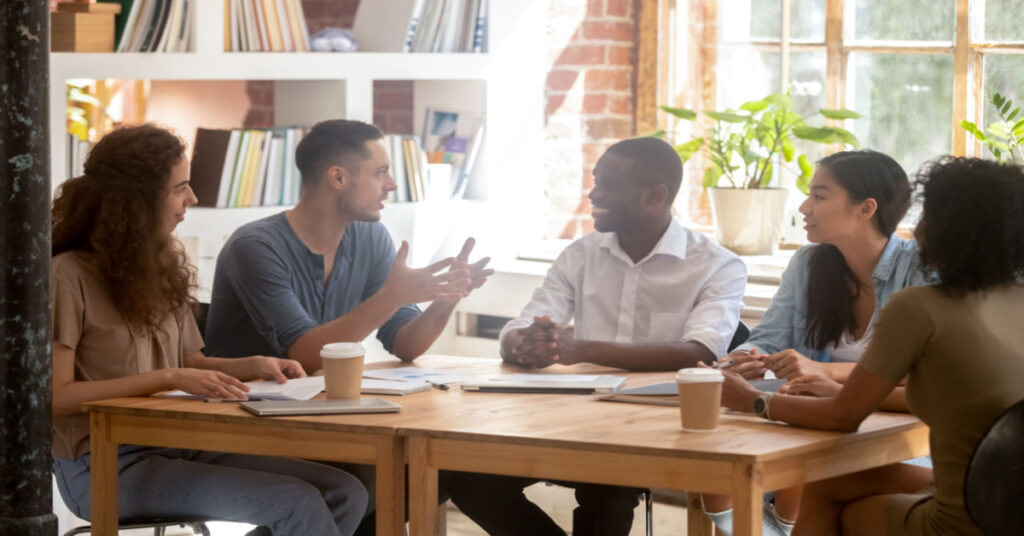 Diverse group of employees listening in the boardroom