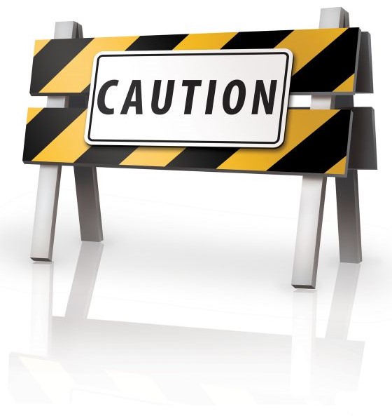 A yellow and back sign with the words Caution