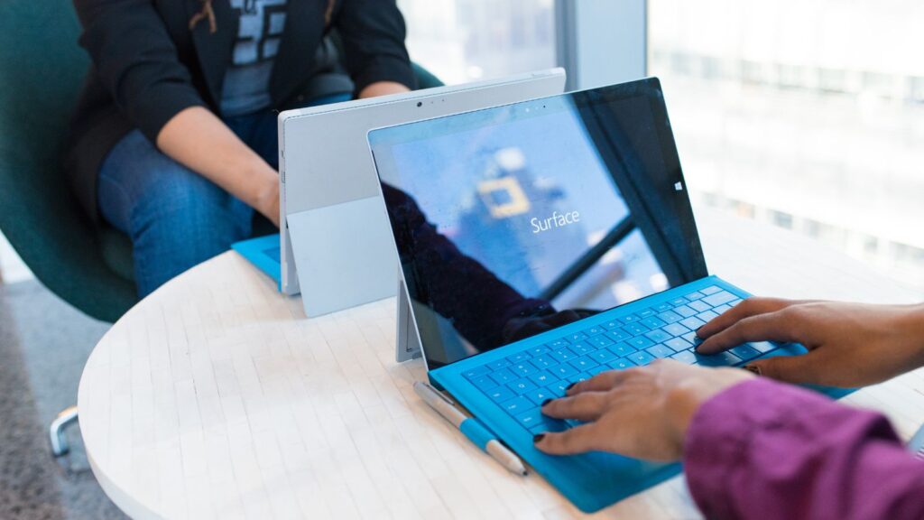 Person Using Microsoft Windows 3 on Table